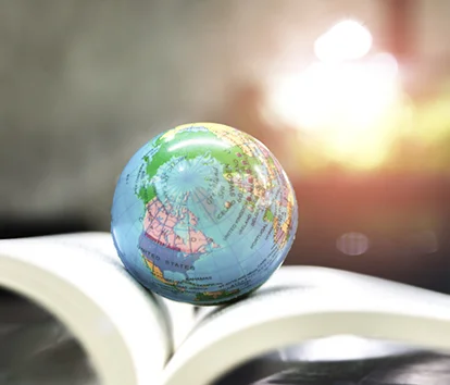 a small globe on an open book